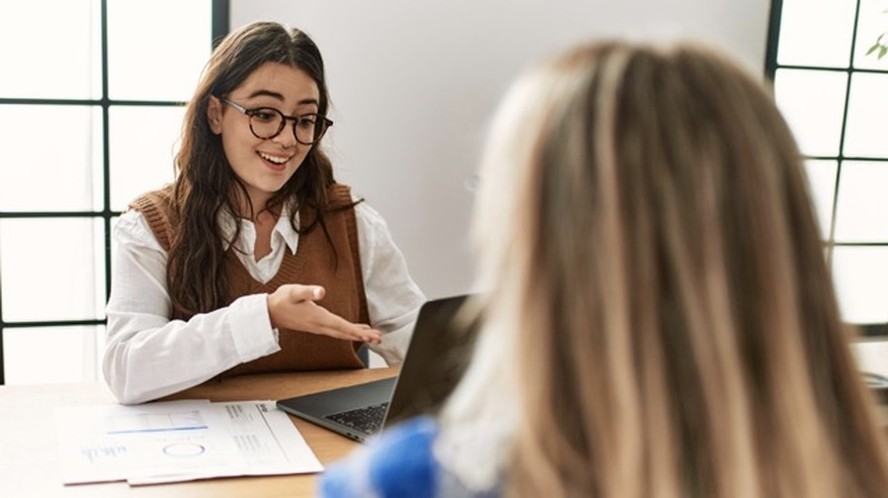 Profissional jovem trabalhando em escritório moderno representando contratação júnior